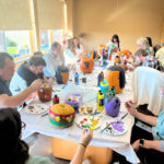 People painting pumpkins