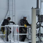 People stafing on a tower